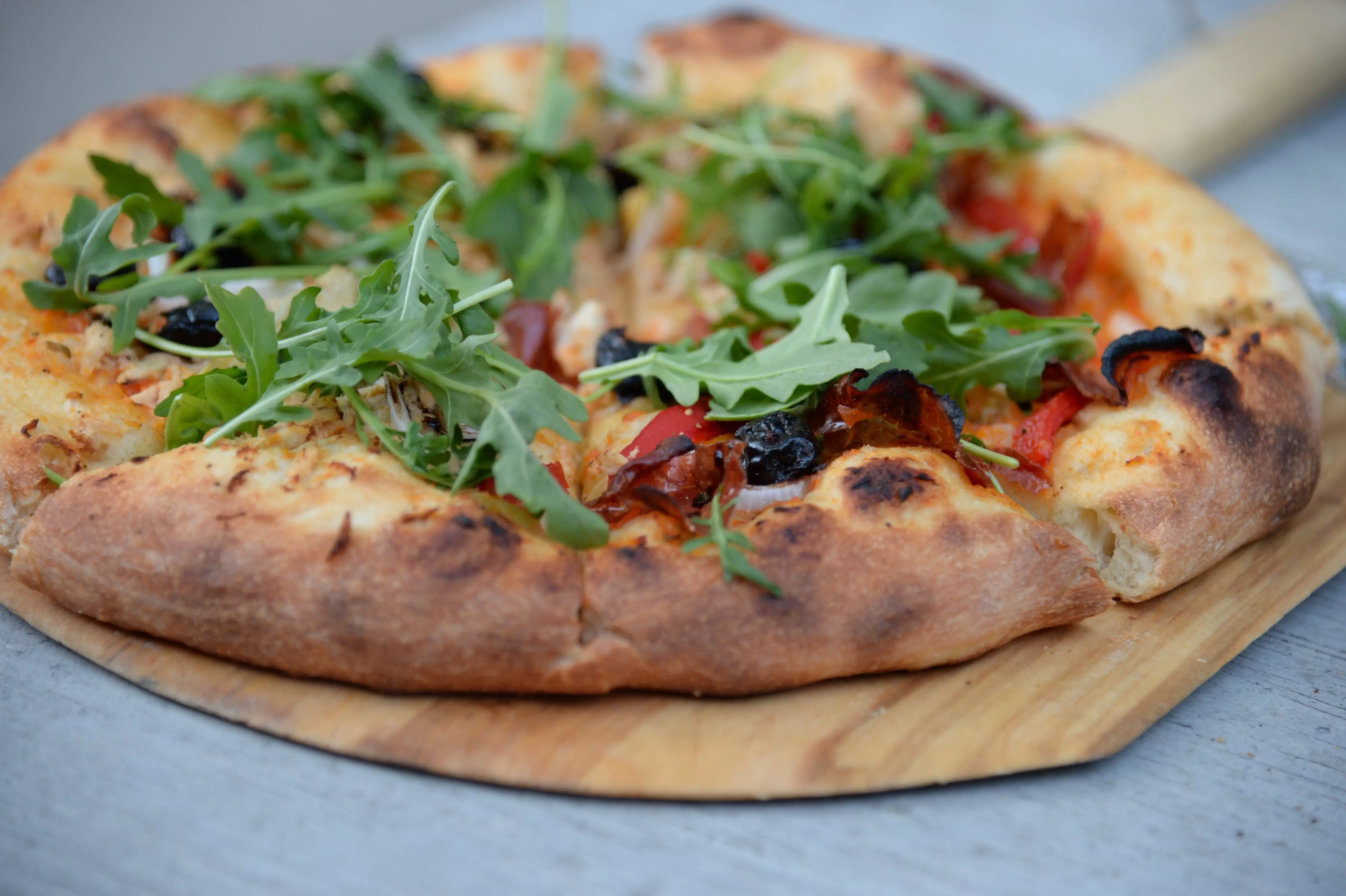 Wood Fired Pizza with Rocket, Olive and Tomatoes