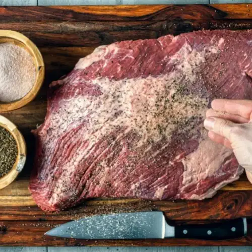 Traeger Brisket Being Seasoned for Dry Brine